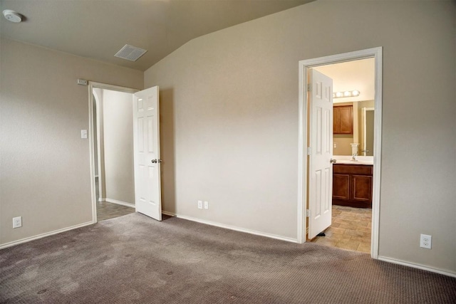 306 Grutsch Dr, Bastrop, TX 78602 - unfurnished bedroom featuring carpet floors, lofted ceiling, and connected bathroom