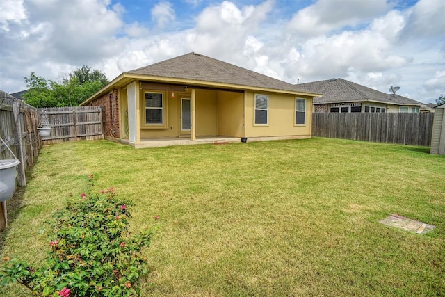 306 Grutsch Dr, Bastrop, TX 78602 - back of property with a patio area, a fenced backyard, and roof with shingles