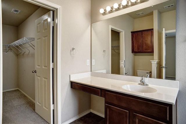 306 Grutsch Dr, Bastrop, TX 78602 - bathroom featuring vanity and a walk in closet