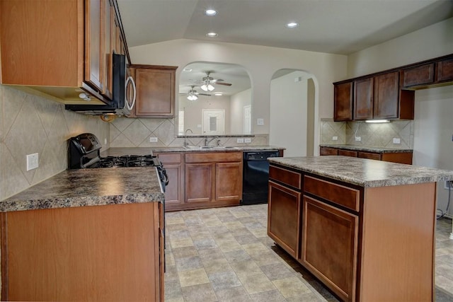 306 Grutsch Dr, Bastrop, TX 78602 - kitchen with dishwasher, a ceiling fan, stainless steel microwave, decorative backsplash, and arched walkways