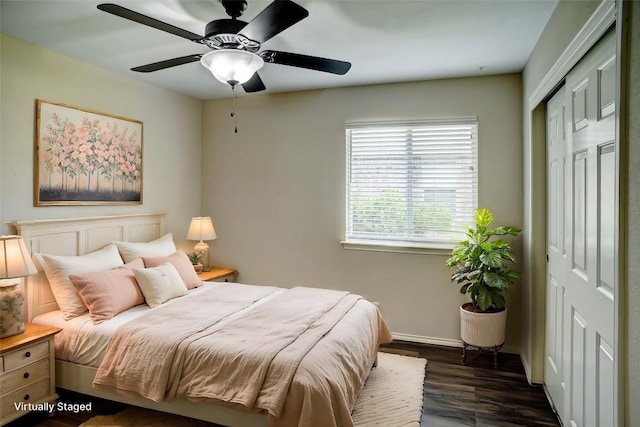 306 Grutsch Dr, Bastrop, TX 78602 - bedroom featuring dark wood finished floors, a closet, and a ceiling fan