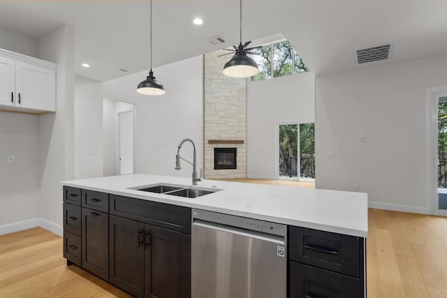 7705 Calcutta Run Dr, Jonestown, TX 78645 - kitchen with dishwasher, white cabinets, plenty of natural light, light wood-type flooring, and a high ceiling