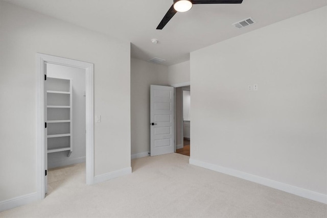 7705 Calcutta Run Dr, Jonestown, TX 78645 - unfurnished bedroom featuring a walk in closet, carpet floors, and a ceiling fan