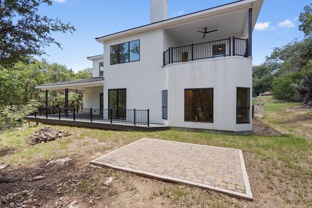 7705 Calcutta Run Dr, Jonestown, TX 78645 - back of house with a ceiling fan, a patio area, a balcony, a chimney, and stucco siding