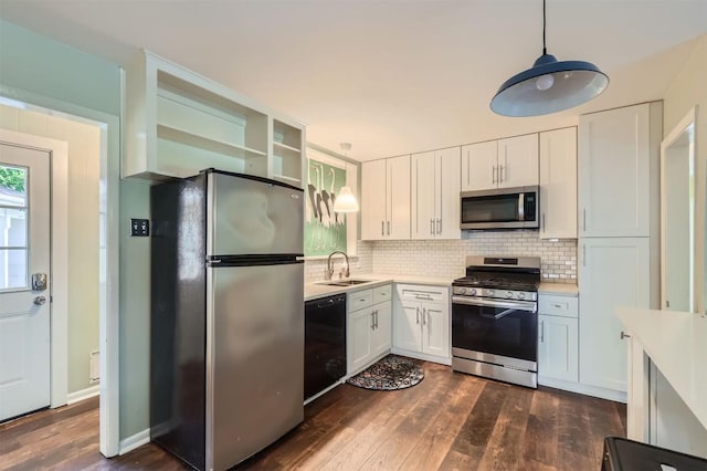 1610 Broadmoor Dr, Austin, TX 78723 - kitchen featuring appliances with stainless steel finishes, light countertops, dark wood-style floors, and white cabinetry