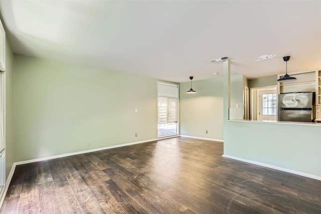 1610 Broadmoor Dr, Austin, TX 78723 - unfurnished living room featuring wood finished floors and baseboards
