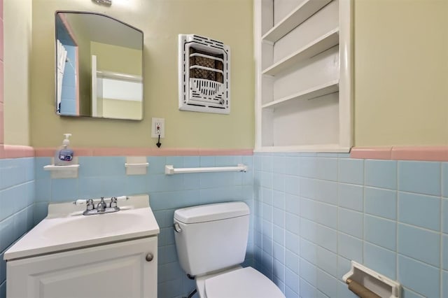 1610 Broadmoor Dr, Austin, TX 78723 - half bathroom with vanity, wainscoting, and tile walls