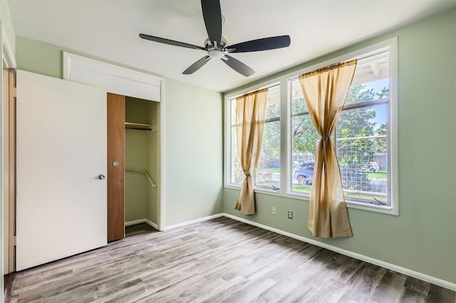 1610 Broadmoor Dr, Austin, TX 78723 - unfurnished bedroom featuring wood finished floors, a closet, and a ceiling fan