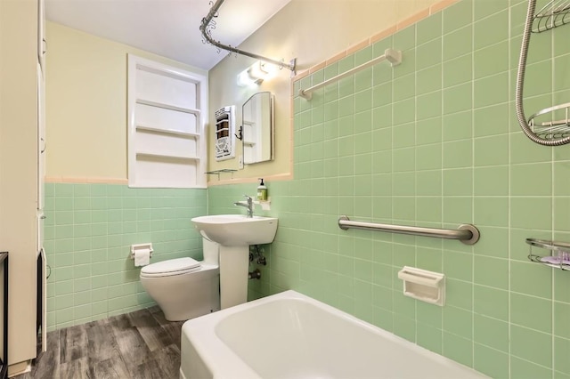 1610 Broadmoor Dr, Austin, TX 78723 - bathroom featuring tile walls and wood finished floors