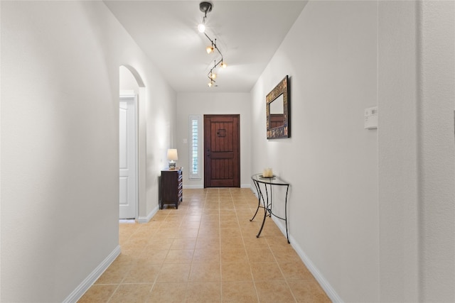 3308 Harvest Time Cv, Austin, TX 78754 - entrance foyer with arched walkways, track lighting, and light tile patterned floors