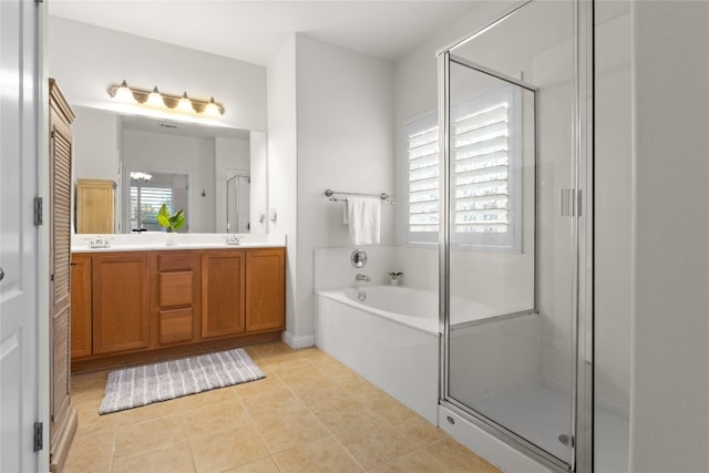 3308 Harvest Time Cv, Austin, TX 78754 - bathroom with double vanity, a garden tub, a stall shower, and tile patterned floors