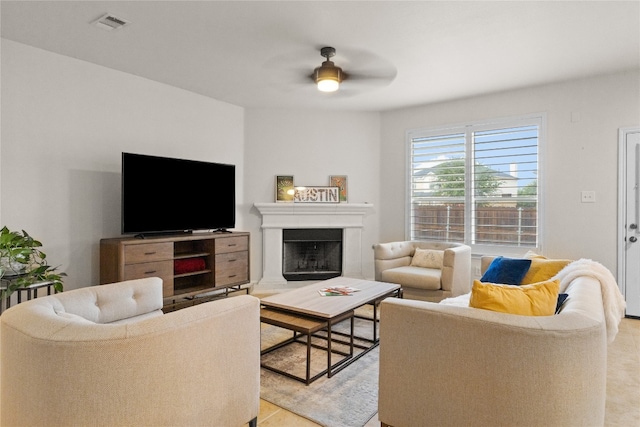 3308 Harvest Time Cv, Austin, TX 78754 - living area with a fireplace with raised hearth and a ceiling fan