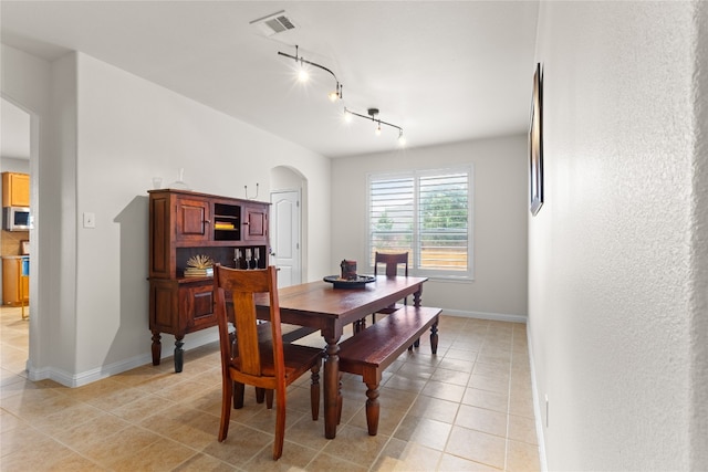 3308 Harvest Time Cv, Austin, TX 78754 - dining room with arched walkways, light tile patterned floors, and track lighting