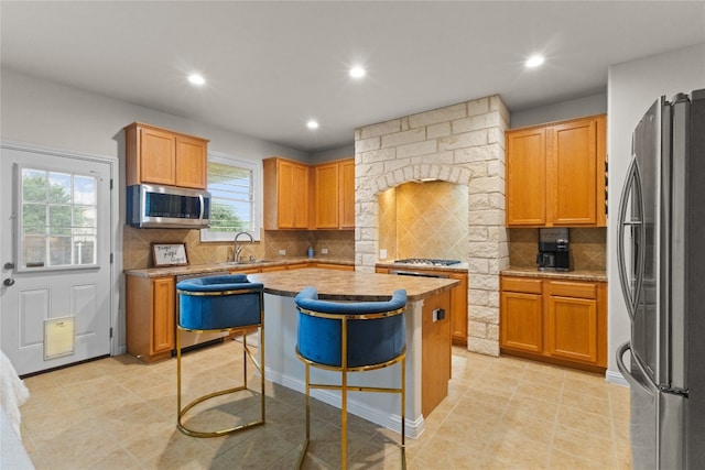 3308 Harvest Time Cv, Austin, TX 78754 - kitchen with appliances with stainless steel finishes, healthy amount of natural light, recessed lighting, a center island, and tasteful backsplash