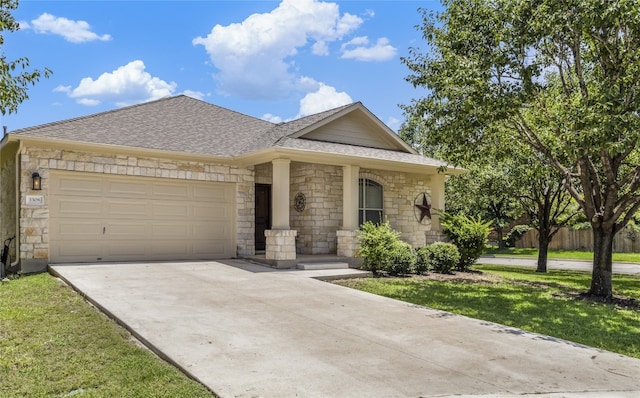 3308 Harvest Time Cv, Austin, TX 78754 - view of front facade with stone siding, driveway, a garage, and roof with shingles