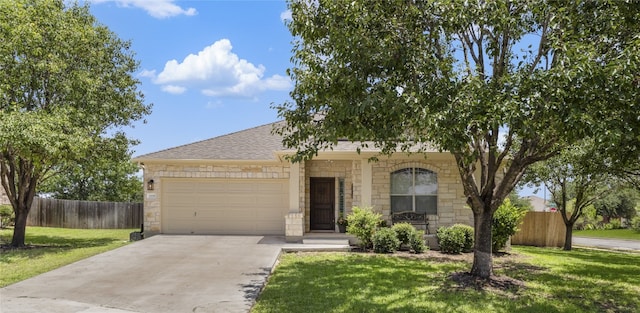 3308 Harvest Time Cv, Austin, TX 78754 - view of front of home featuring driveway, an attached garage, stone siding, and a shingled roof