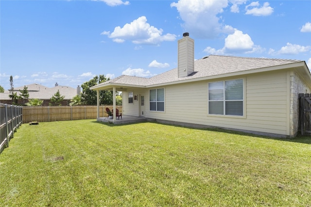 3308 Harvest Time Cv, Austin, TX 78754 - back of house with a fenced backyard, a chimney, and a patio