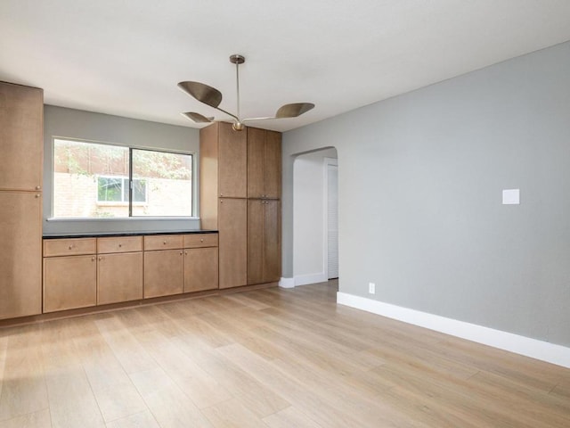 5314 Presidio Rd, Austin, TX 78745 - unfurnished room with light wood-style floors, ceiling fan, and arched walkways