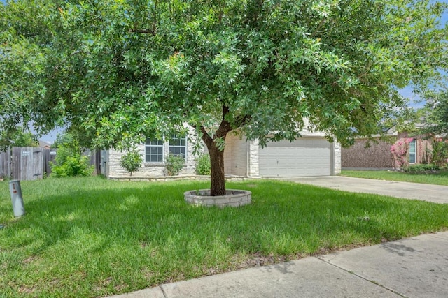 109 Inman Dr, Hutto, TX 78634 - obstructed view of property with concrete driveway, an attached garage, and stone siding