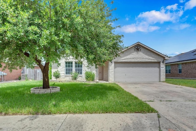 109 Inman Dr, Hutto, TX 78634 - view of front of house featuring driveway, a front yard, an attached garage, and stone siding