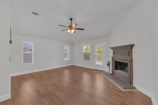 109 Inman Dr, Hutto, TX 78634 - unfurnished living room with a ceiling fan, wood finished floors, and a fireplace with raised hearth