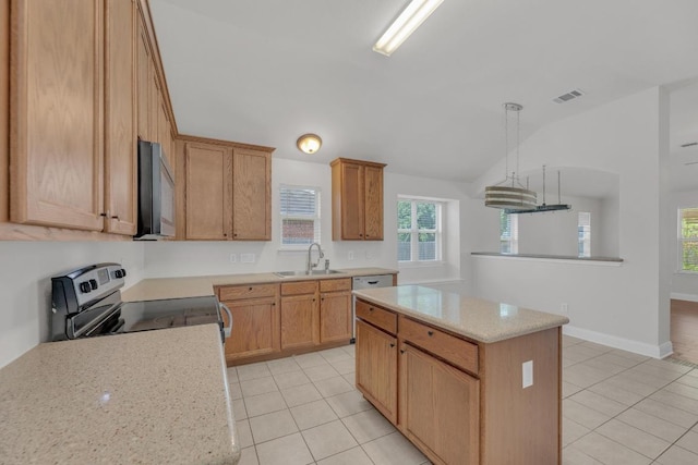 109 Inman Dr, Hutto, TX 78634 - kitchen featuring appliances with stainless steel finishes, lofted ceiling, light tile patterned floors, a kitchen island, and hanging light fixtures
