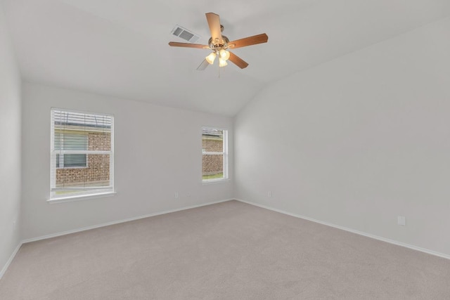 109 Inman Dr, Hutto, TX 78634 - spare room featuring vaulted ceiling, light carpet, and a ceiling fan