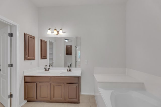 109 Inman Dr, Hutto, TX 78634 - bathroom featuring a garden tub, tile patterned floors, and double vanity