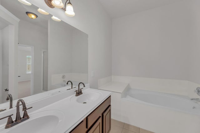109 Inman Dr, Hutto, TX 78634 - bathroom featuring a garden tub, double vanity, and tile patterned flooring