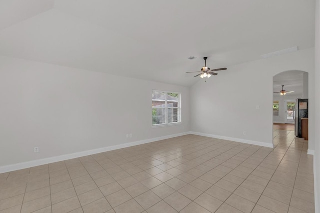 109 Inman Dr, Hutto, TX 78634 - unfurnished room featuring ceiling fan, vaulted ceiling, arched walkways, and light tile patterned floors