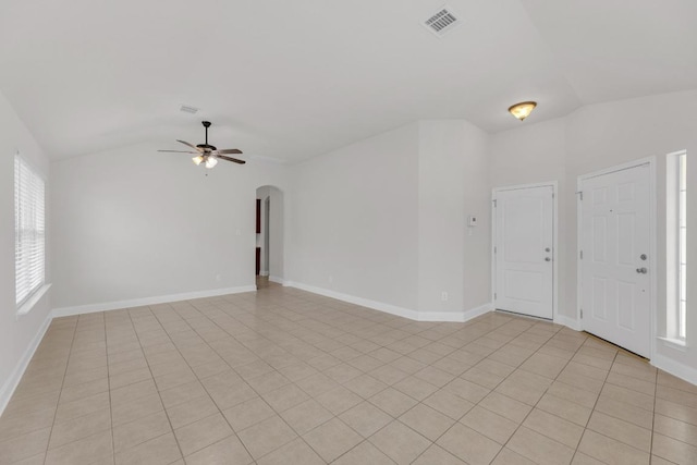 109 Inman Dr, Hutto, TX 78634 - empty room with vaulted ceiling, ceiling fan, arched walkways, and light tile patterned floors