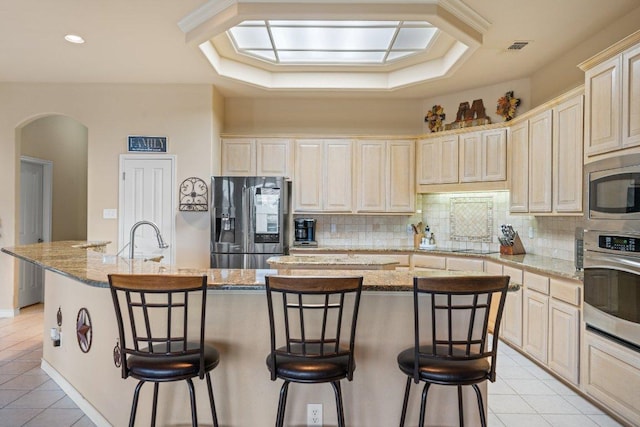 106 Mesquite Trl, Boerne, TX 78006 - kitchen with appliances with stainless steel finishes, arched walkways, light tile patterned floors, backsplash, and recessed lighting