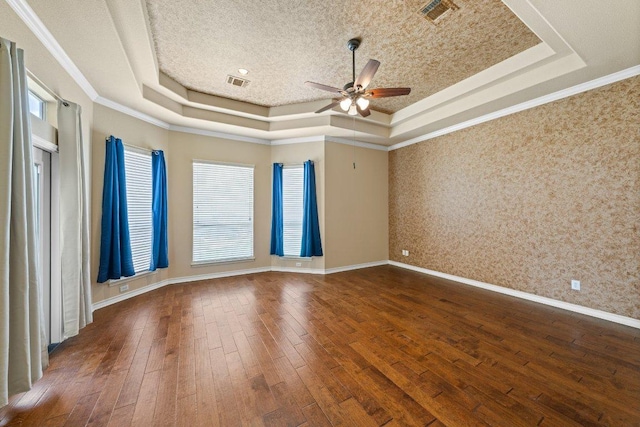 106 Mesquite Trl, Boerne, TX 78006 - empty room with a raised ceiling, a ceiling fan, wallpapered walls, dark wood-style floors, and ornamental molding
