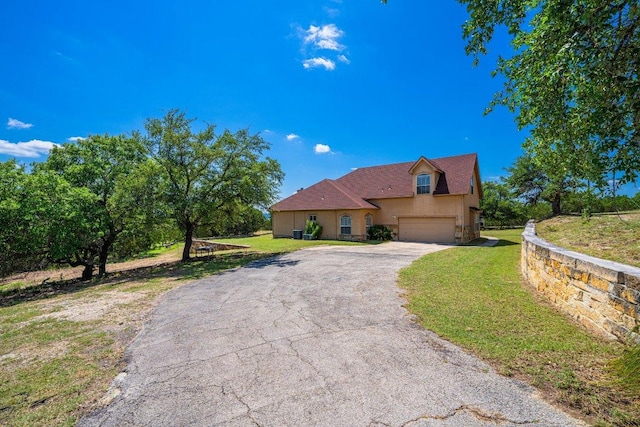106 Mesquite Trl, Boerne, TX 78006 - view of front of home with driveway, stucco siding, a front lawn, and a garage