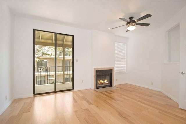 611 E 45th St Unit 8, Austin, TX 78751 - unfurnished living room with light wood-style flooring, a fireplace with flush hearth, and a ceiling fan