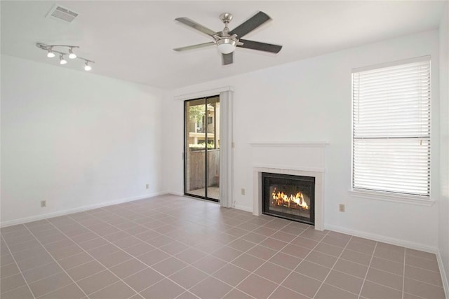 611 E 45th St Unit 8, Austin, TX 78751 - unfurnished living room featuring ceiling fan, a glass covered fireplace, and tile patterned floors