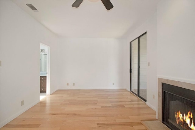 611 E 45th St Unit 8, Austin, TX 78751 - unfurnished living room with a fireplace with flush hearth, light wood-style flooring, and ceiling fan