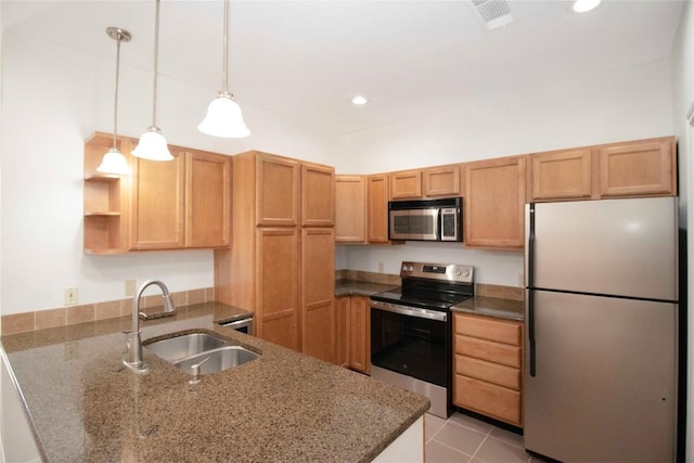 611 E 45th St Unit 8, Austin, TX 78751 - kitchen with appliances with stainless steel finishes, a peninsula, dark stone countertops, decorative light fixtures, and open shelves