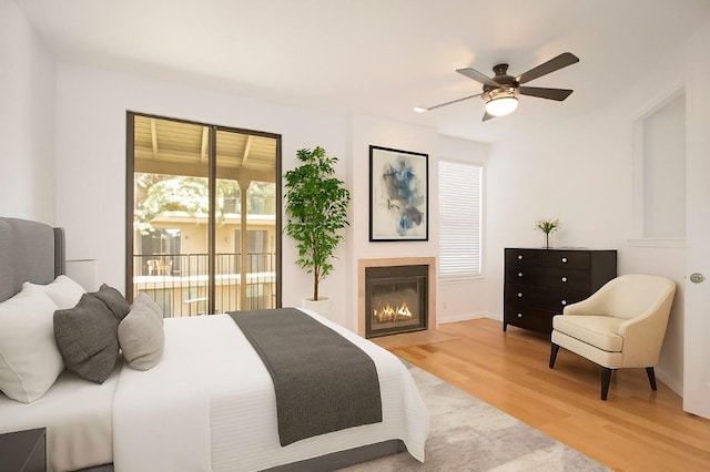 611 E 45th St Unit 8, Austin, TX 78751 - bedroom with light wood-type flooring, a glass covered fireplace, access to outside, and ceiling fan