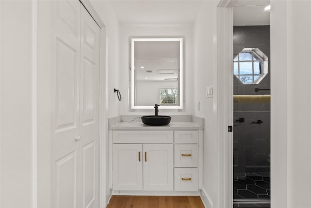 2706 Wheless Ln Unit 401, Austin, TX 78723 - bathroom featuring vanity, plenty of natural light, and wood finished floors