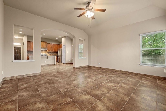 18712 Leigh Ln, Pflugerville, TX 78660 - unfurnished living room featuring arched walkways, a ceiling fan, recessed lighting, and vaulted ceiling