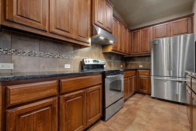 18712 Leigh Ln, Pflugerville, TX 78660 - kitchen featuring stainless steel appliances, under cabinet range hood, tasteful backsplash, brown cabinetry, and dark stone counters
