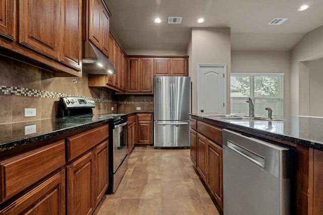 18712 Leigh Ln, Pflugerville, TX 78660 - kitchen with stainless steel appliances, under cabinet range hood, tasteful backsplash, recessed lighting, and dark stone counters