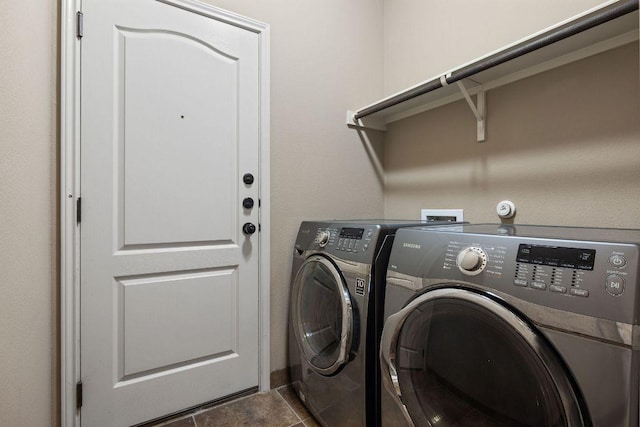 18712 Leigh Ln, Pflugerville, TX 78660 - laundry room with washer and clothes dryer and dark tile patterned floors