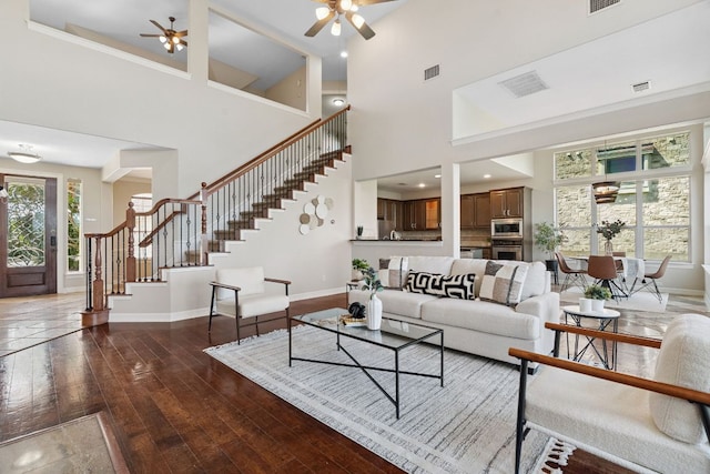 7204 Covered Bridge Dr, Austin, TX 78736 - living room featuring a ceiling fan, stairs, wood-type flooring, and a high ceiling