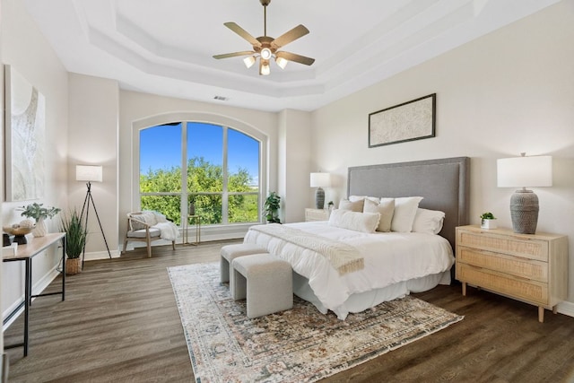 7204 Covered Bridge Dr, Austin, TX 78736 - bedroom featuring a tray ceiling, dark wood-type flooring, and ceiling fan