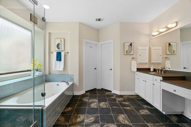 7204 Covered Bridge Dr, Austin, TX 78736 - bathroom with vanity, a garden tub, and a shower with shower door