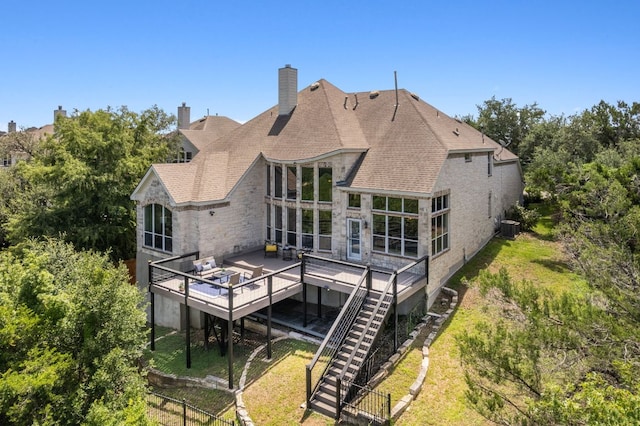 7204 Covered Bridge Dr, Austin, TX 78736 - rear view of property with a wooden deck, stone siding, a lawn, a chimney, and stairs
