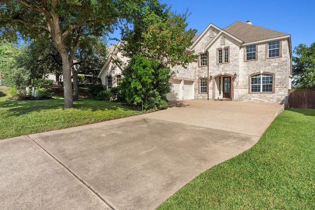 7204 Covered Bridge Dr, Austin, TX 78736 - french country home with concrete driveway, stone siding, and a garage
