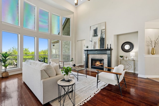 7204 Covered Bridge Dr, Austin, TX 78736 - living area featuring a high ceiling, a tiled fireplace, hardwood / wood-style floors, and a ceiling fan